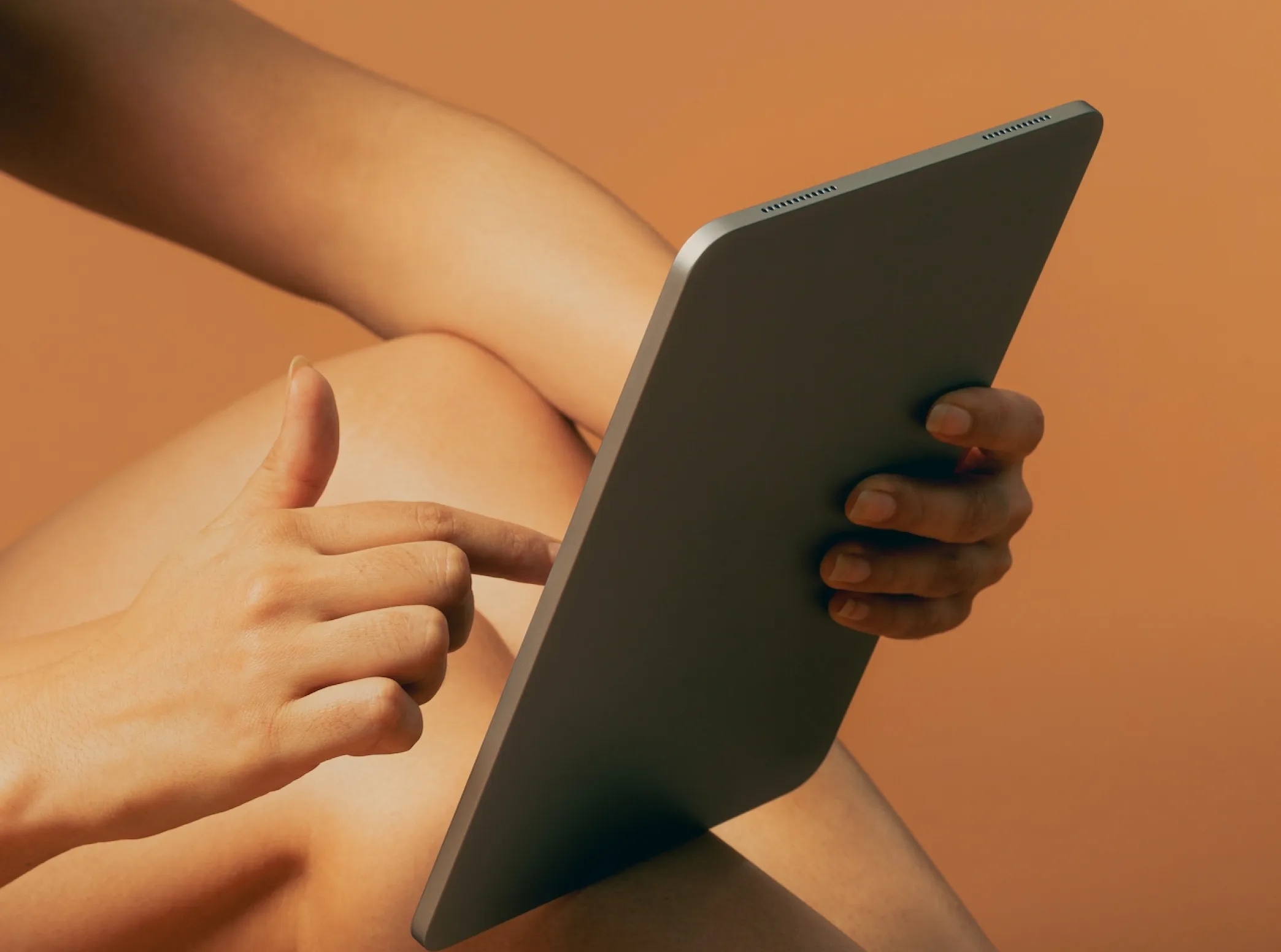 a person holding a tablet in their right hand