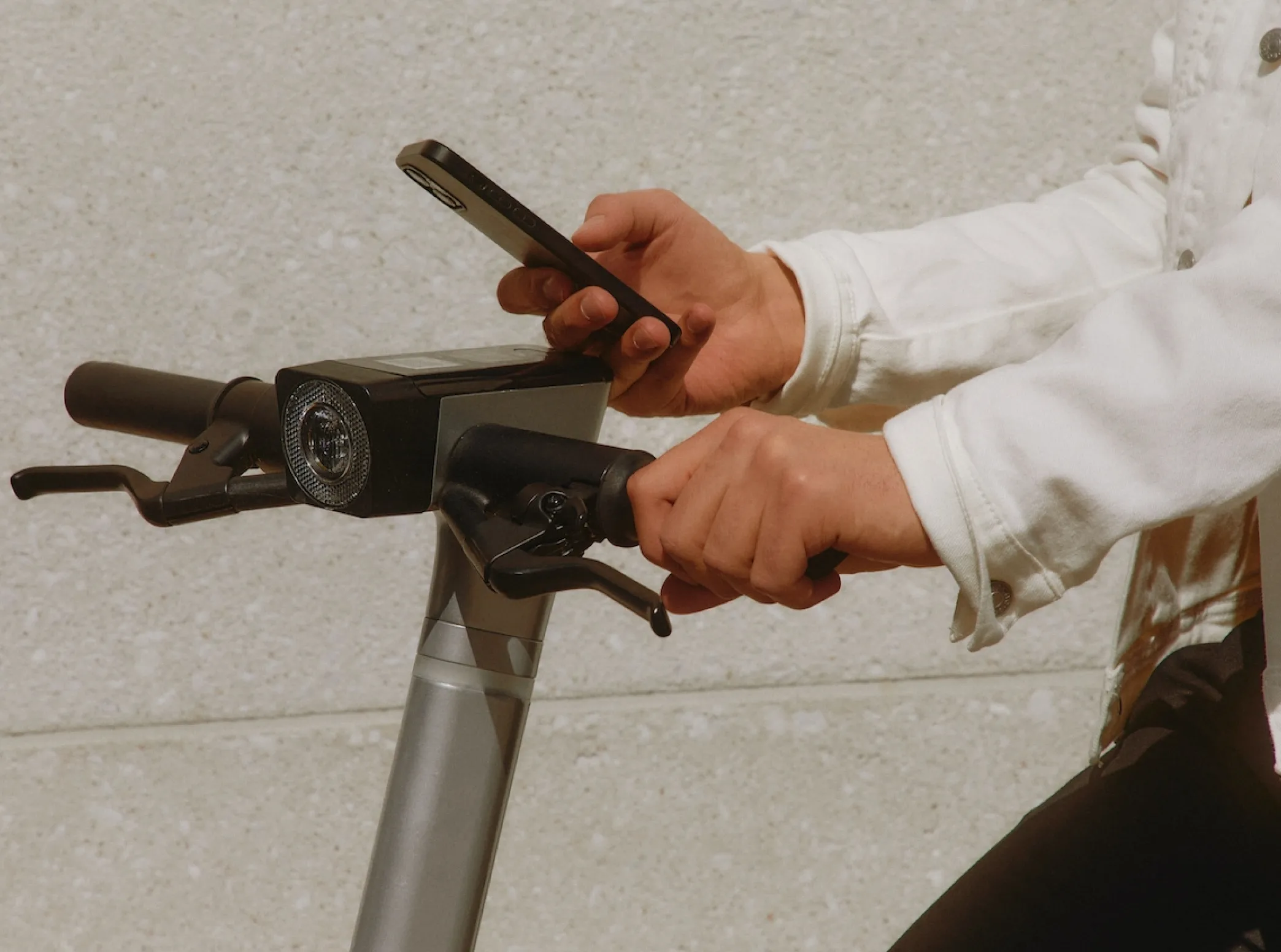 a person on a bike using a cell phone
