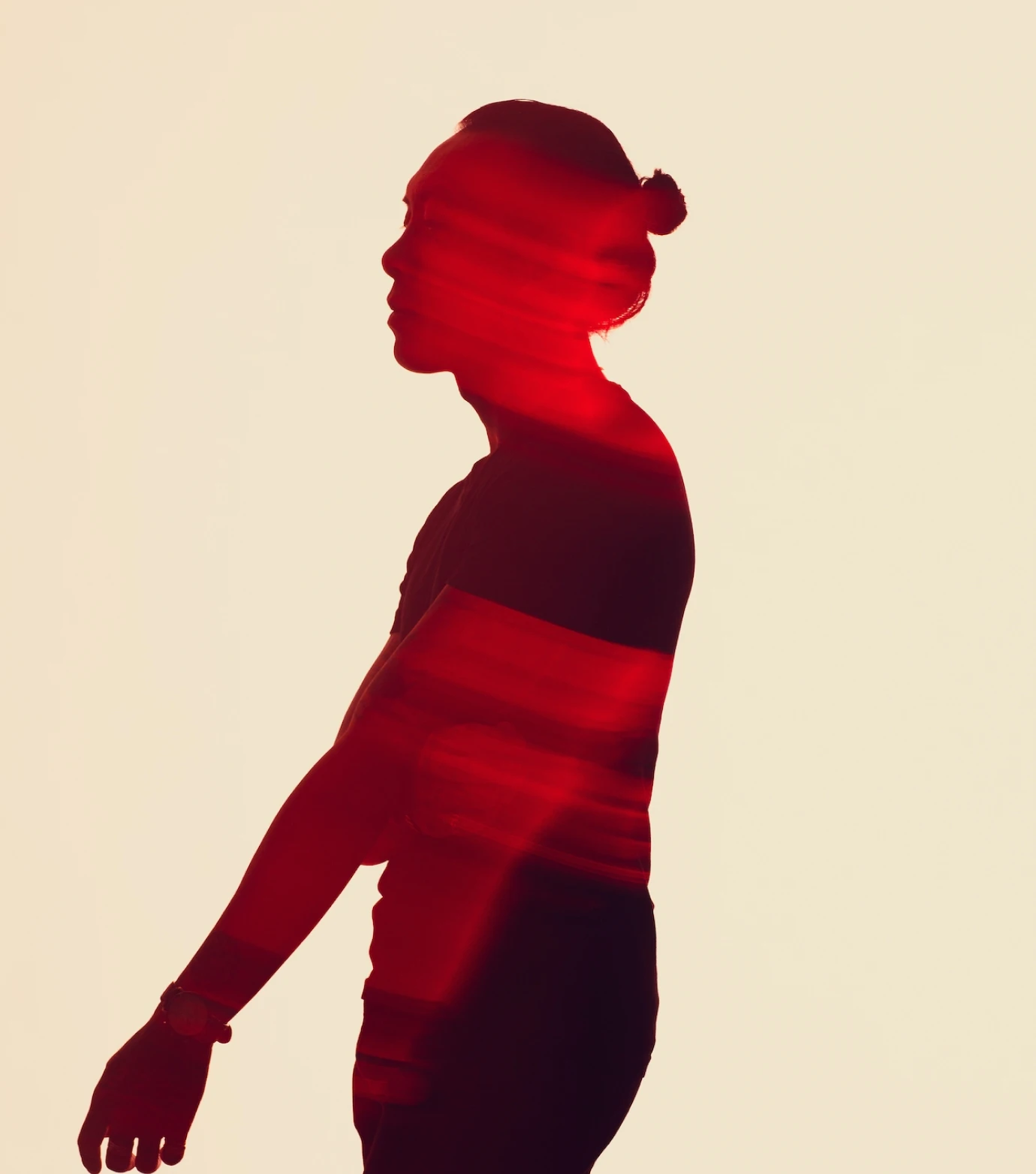 a silhouette of a person holding a skateboard